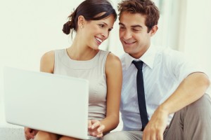 Young business couple working on laptop